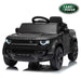 A matte black Land Rover Defender kids' ride-on toy car with a matchiBlack Land Rover Defender 110 12V kids ride-on carng black steering wheel and black wheels, shown on a white background with a reflection and a Land Rover logo badge in the top right corner.