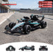 A black and teal Mercedes F1 race car shown on a racetrack with overlaid dimensions and small front/back views along the bottom. The image includes size labels and a 'DIMENSION' graphic, but the main content is still the product itself rather than a standalone measurement chart, so subject_type is Product/Packaging. Mercedes-AMG F1 W16 24V lithium ride-on car specifications with dual motors and safety seatbelt